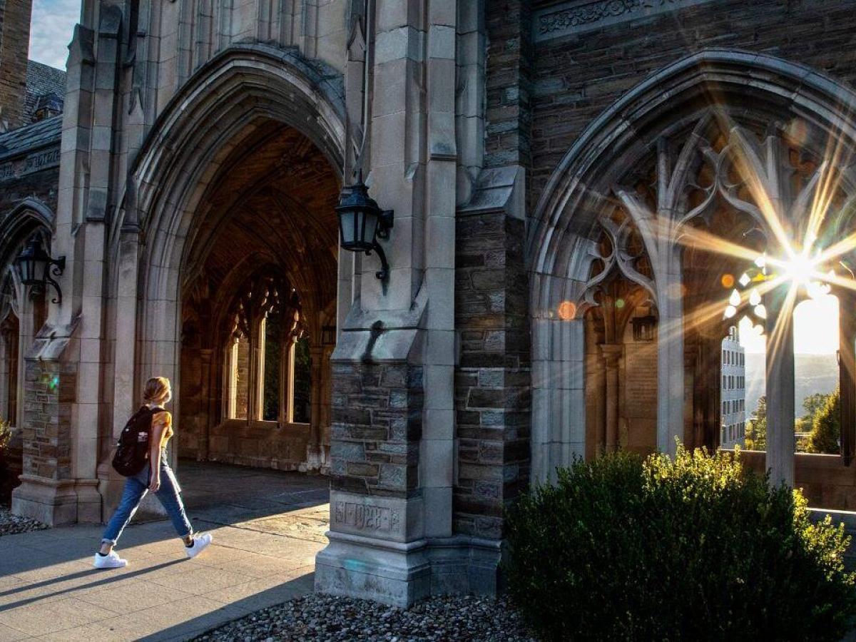 Cornell University stone arcade campus building at sunset