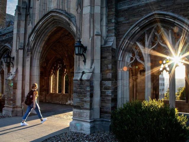 Cornell University stone arcade campus building at sunset